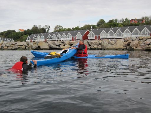 Kajakken tømmes for vand i en makkerredning. Kajak på Bornholm.